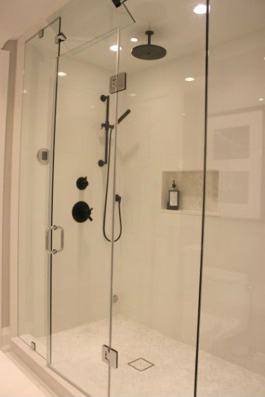Open up the bathroom with glass shower enclosures